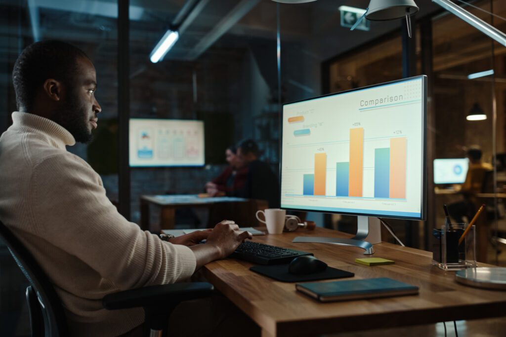 A customer looks at a chart comparing the statistics of commission software. 