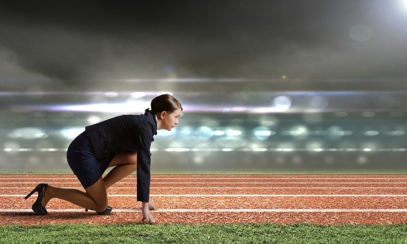 A sales rep prepares to run a race, illustrating the figurative journey to sales quota attainment.