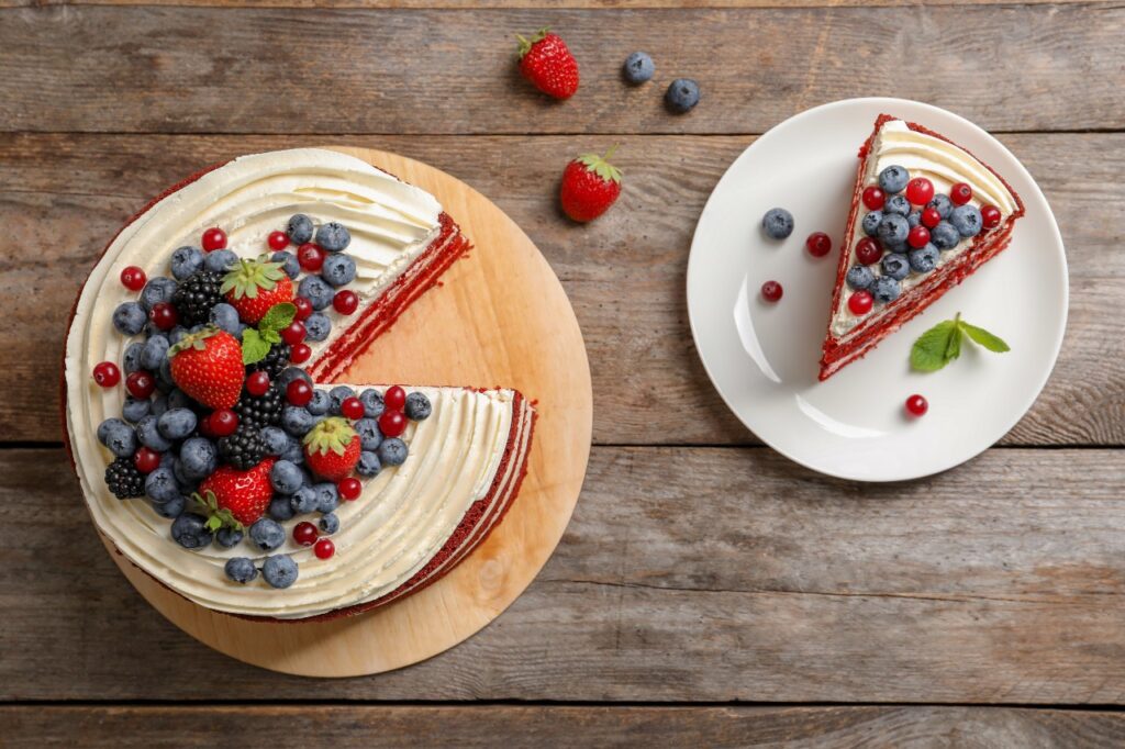 A cake with various types of berries has a slice removed, figuratively referring to how commissions are split among sales team members.