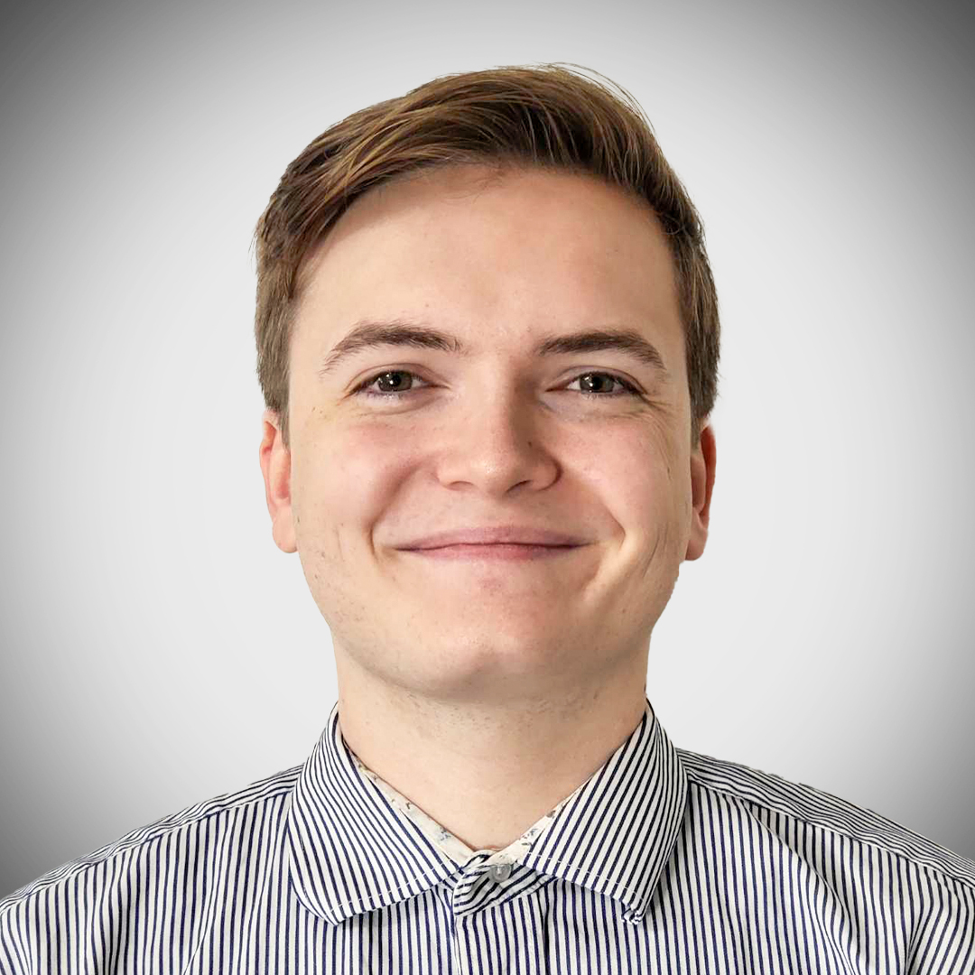Conor Edgecumbe, a systems implementer at Core Commissions, is pictured in a collared shirt against a white background