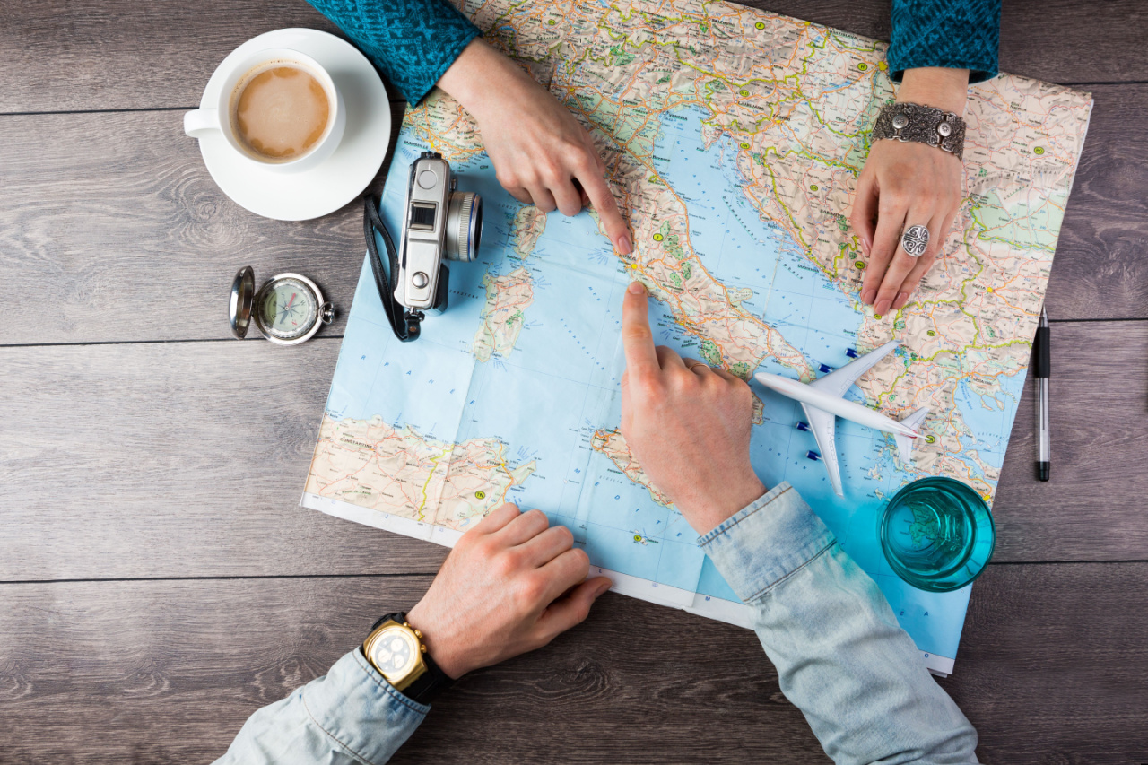 Travel agents look at world map to plan travel arrangements for clients.